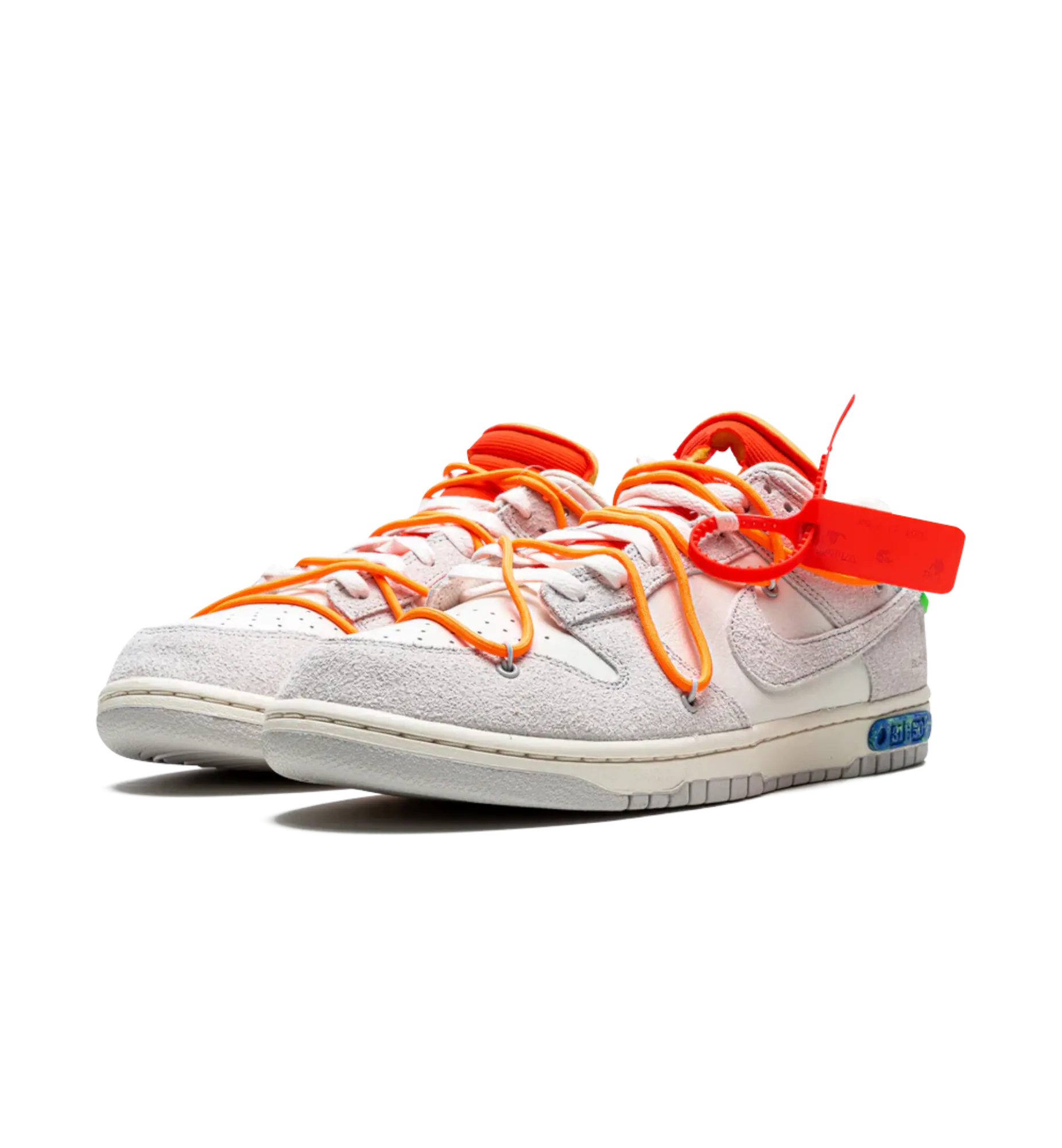 White sneakers with orange laces and a red tag on a white background