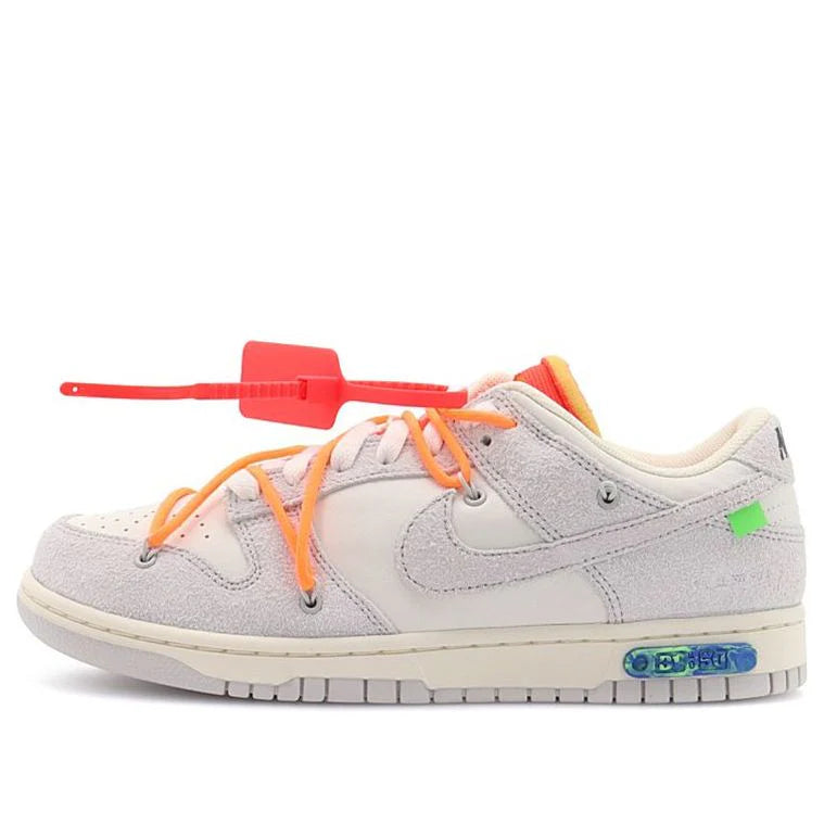 Gray sneaker with orange laces on a white background