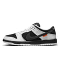 Black and white sneaker with orange label on a white background