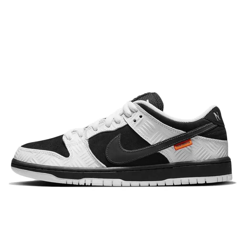 Black and white sneaker with orange label on a white background